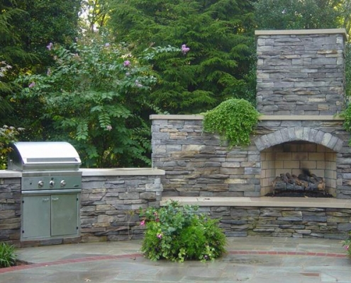 outdoor grill with stone fireplace