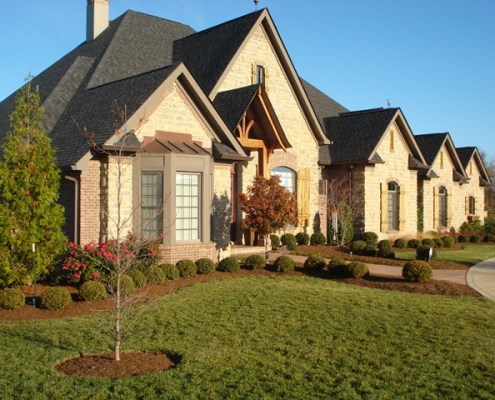 Front yard landscape accenting home and entrance port