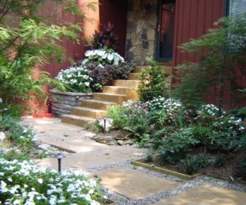 Japanese garden with stone walkway and flowers accenting entrance port