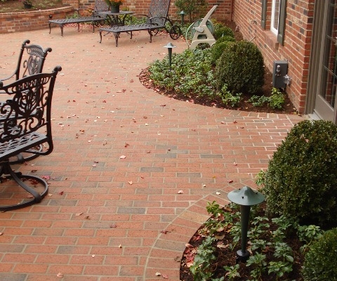 Outdoor patio with a raised brick circular flower bed