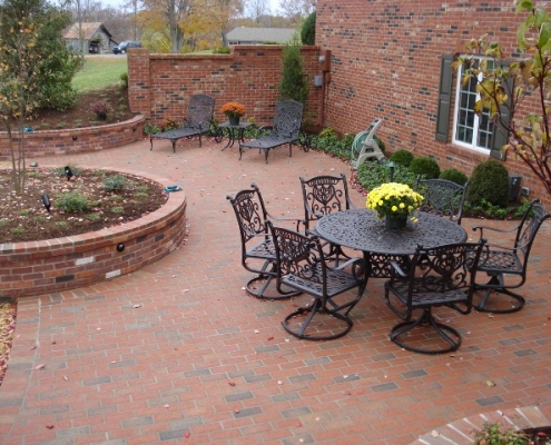 an outdoor patio with a raised brick flower bed in Louisville, Kentucky