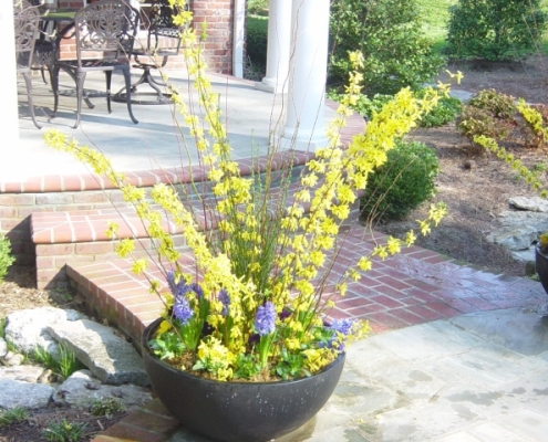 flowering planter accenting an outdoor landscape structure