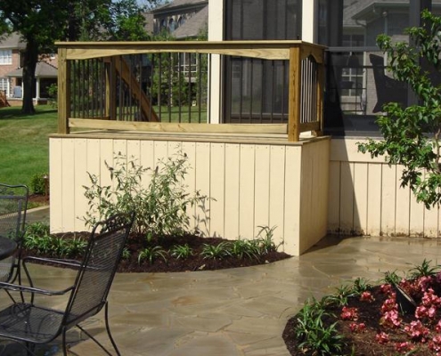 A woodwork deck and stone patio designed by Dwyer DesignScapes